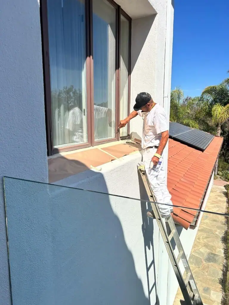 High-quality house painting services focusing on window frame and exterior wall painting, enhancing curb appeal.